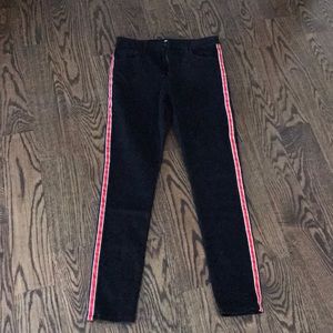 Super cute black jeans with red stripe on the side